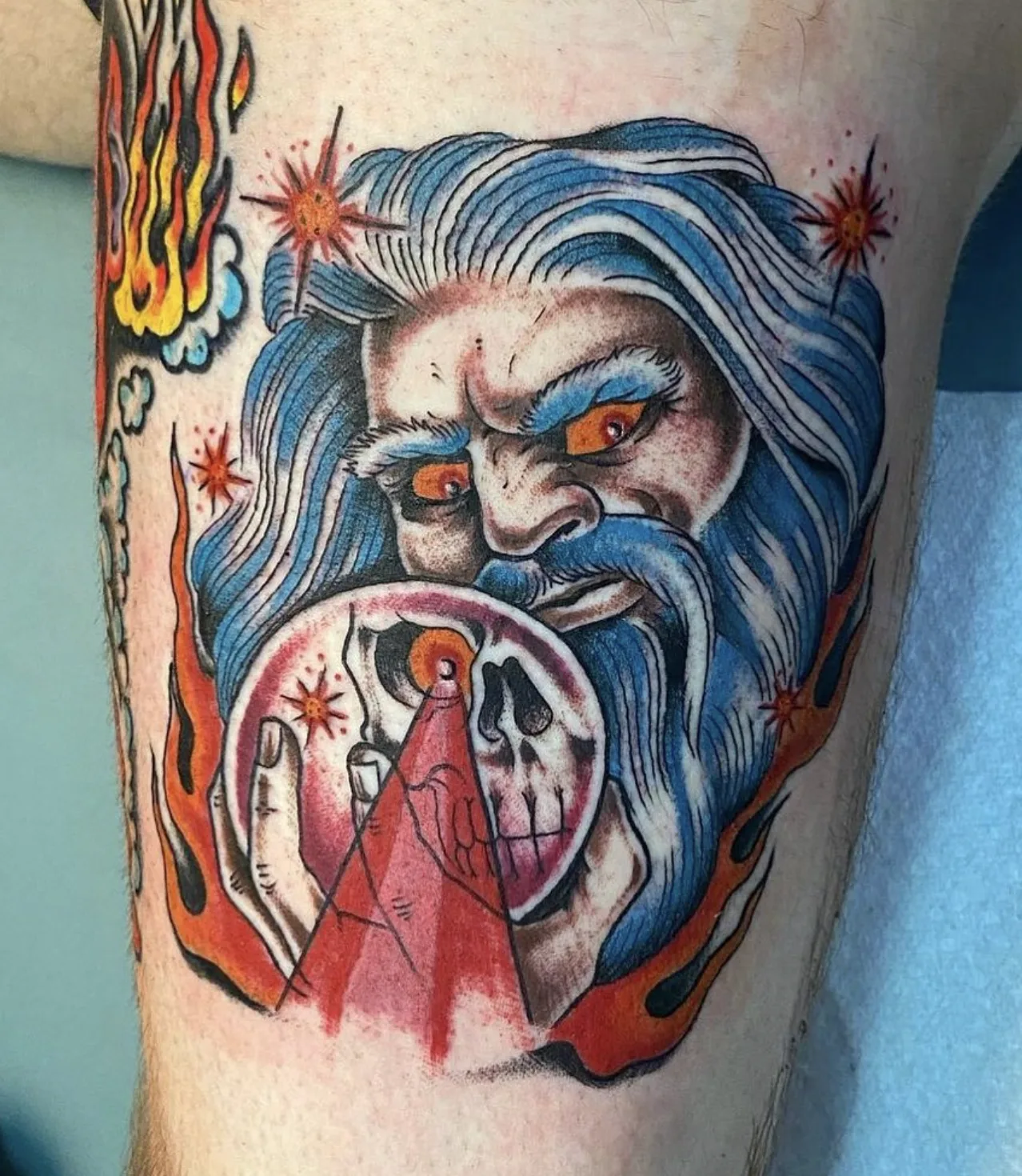 Wizard conjuring a skull inside a crystal ball, surrounded by flames and stars
